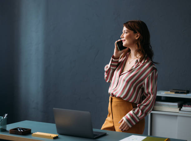 istock Professional Woman Talking on Phone in Modern Office Setting 2035915632