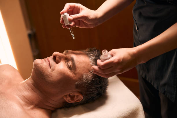 istock Experienced masseuse preparing client for facial massage 2035950639