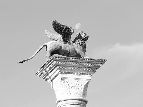 statue of the winged lion of saint mark symbol of the city of venice above the column with white and black effect