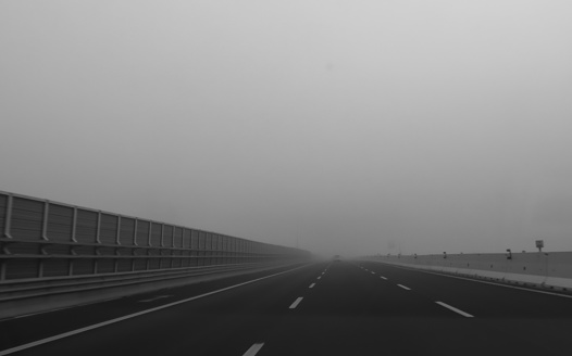 thick fog on the motorway with poor visibility and risk of accidents and you need to drive carefully