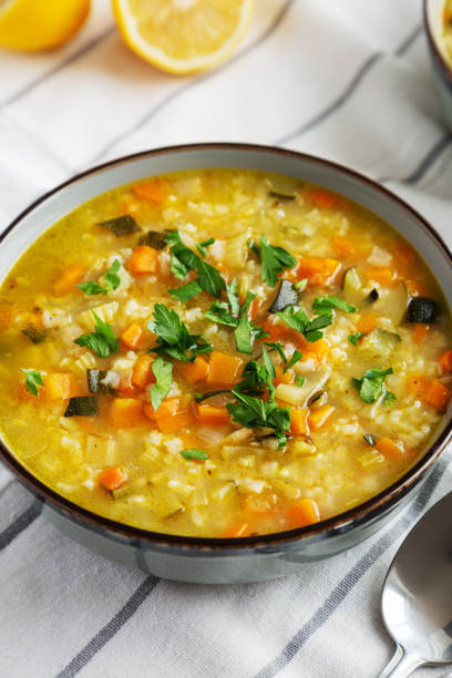 istock Homemade fresh lemon rice soup in a bowl, side view. Close-up. 2035968072