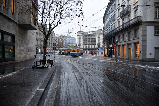 The famous Paradeplatz in the Center of Zurich City. Arround the town square are the biggest banks of switzerland situated. It is also a point where several Trams are crossing and people go for work. The image was captured during heavy snowfall in winter season.