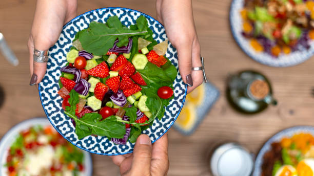 istock person holding a bowl of salad 2035986268