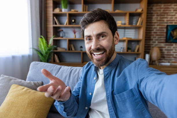 istock Cheerful man taking selfie at home: Lifestyle, technology, and connection 2035998160