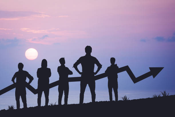 istock Team silhouette and up graph arrow on sunset background, leadership and teamwork concept 2036013713