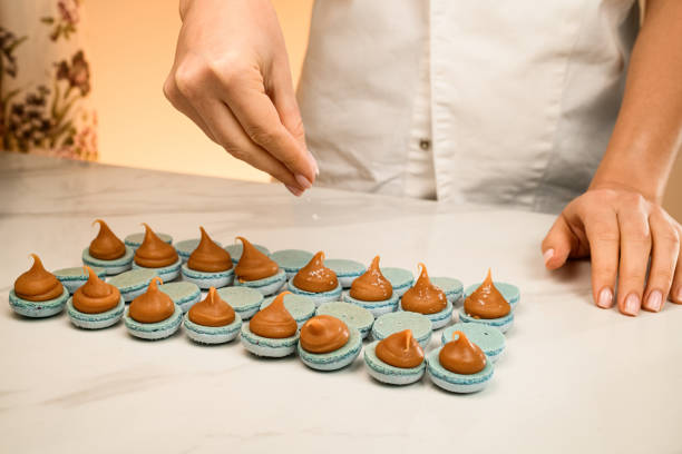 istock Making macarons on a white table by a culinary girl specialist 2036057331