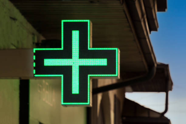 istock Green pharmacy glowing sign on street 2036064497