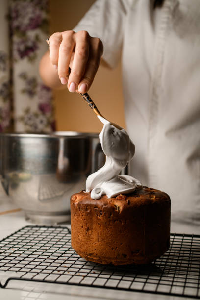 Confectioner making thick white cream for decorating a cake from almond flour