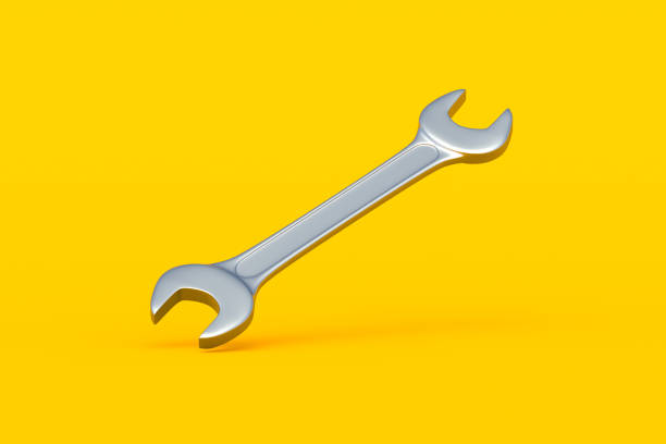 Falling spanner on yellow background. Metal wrench in workshop. Repair and maintenance tool. 3d render