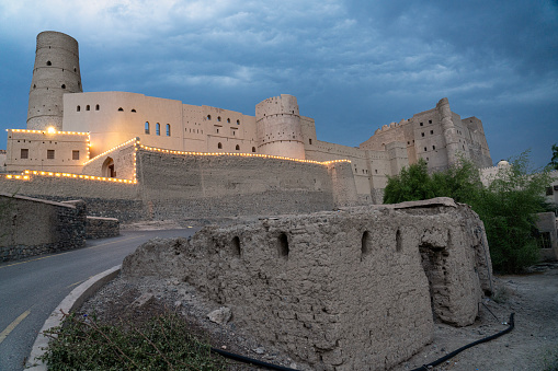 Historic Bahla Fort located at Djebel Akhdar highlands in the Sultanate of Oman illuminated at night.