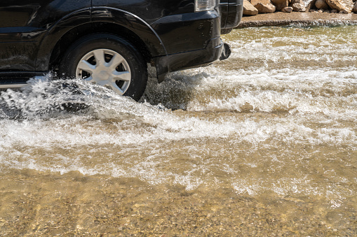 Cars driving on flooded road after heavy rain to oasis Wadi Bani Khalid.  Oman