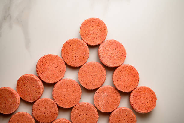istock Pink half blanks for the French macaroon dessert on a white background 2036126602