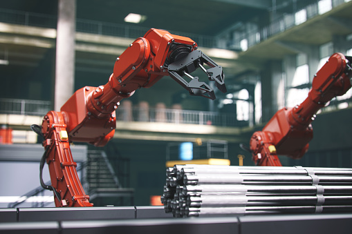 Industrial robots at the automated manufacturing factory assembly line.