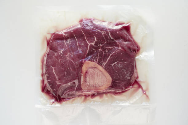 istock Organic beef (Osso buco ) in a vacuum sealed package with white background 2036176583