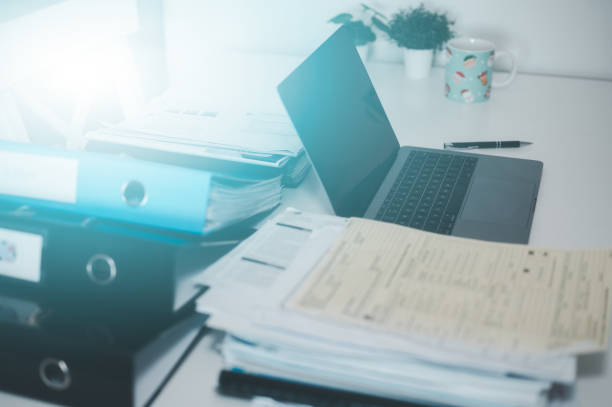 istock document data management, files and data management, bills expenses ,daily expenses, busy table with document and computer laptop 2036221324