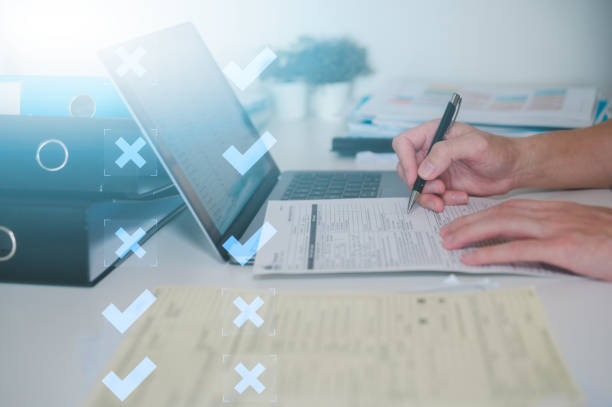 istock Corporate Focus Executive Efficiency Businessman at Work with busy table with document and laptop Documents data management, Documented Decisions Businessman Strategizing files and data management 2036223923
