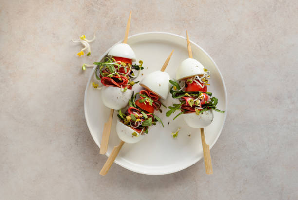 istock Eggs and meat salad on skewers overhead view on a plate 2036266628