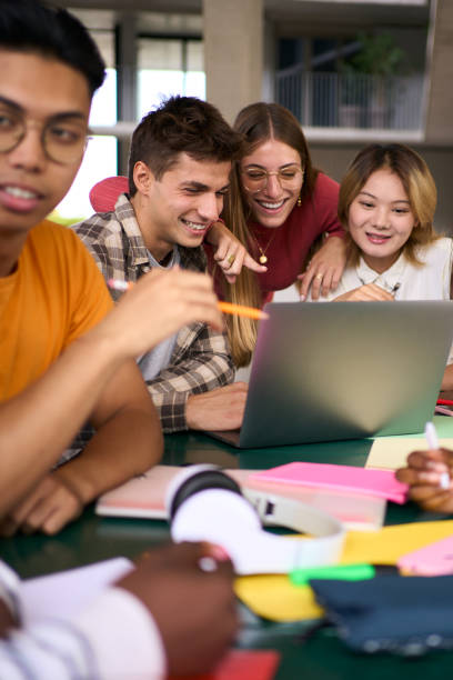 istock Selective focus on a smiling male young university student using laptop in the classroom 2036281024