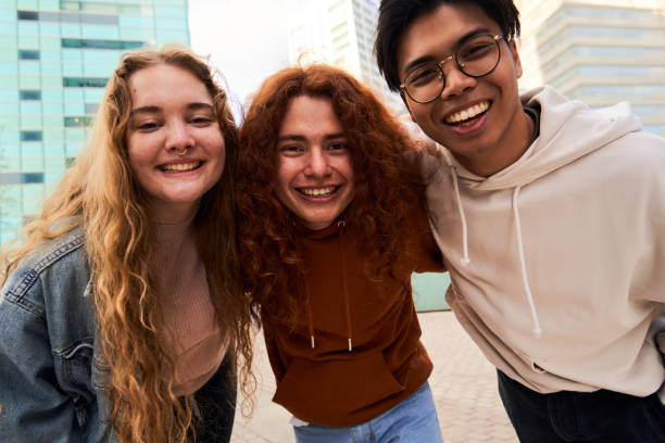 istock Group of student friends having fun outdoors looking at camera smiling. 2036291388