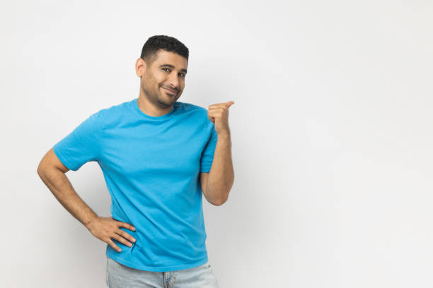 istock Smiling satisfied unshaven man indicating at advertisement area, copy space for promotion. 2036398841