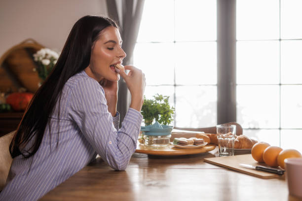 istock Woman sitting at dining table, simply contemplating and relaxing 2036403387