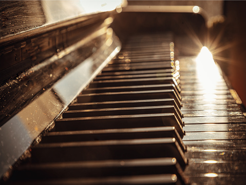 Side view of Classic grand piano keyboard. Antique piano keys and wood grain with sepia tone, Instrument musical tool, Space for text, Selective focus.