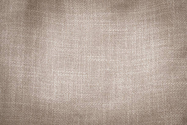 Upholstery orange colored jacquard fabric diagonal coarse weave texture close up, macro. Textile background, furniture textile material, wallpaper, backdrop. Cloth structure close up, macro