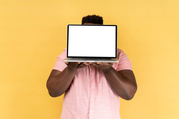 istock Man hiding face behind laptop with white empty display and presenting new applications. 2036415184