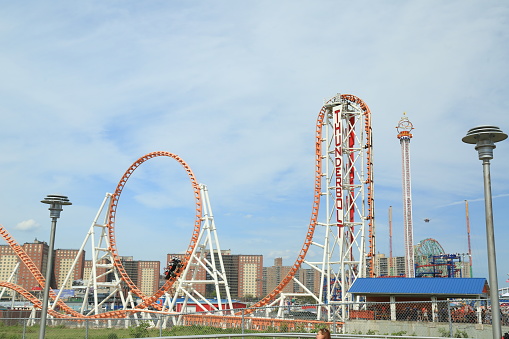 Roller coaster in the amusement park with the sunset background.