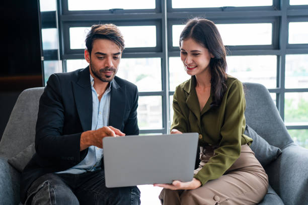 istock Two happy business woman and man using laptop working on computer at workplace. 2036483590