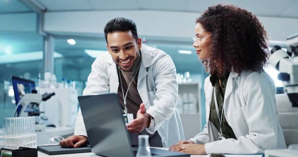 istock Scientist, teamwork and happy with laptop in laboratory for test breakthrough, pharmaceutical review or success. Science, collaboration or technology for research, discussion and digital analysis 2036497138