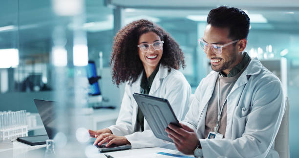 istock Science, teamwork and laptop with laughing in laboratory for communication, pharmaceutical review or planning. Employees, collaboration and technology for research, discussion and digital analysis 2036497145