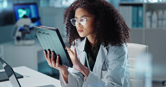 Tablet, reading and woman scientist in laboratory working on medical research, project or experiment. Science, career and female researcher with digital technology for pharmaceutical innovation.