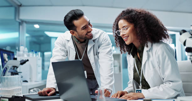 istock Scientist, teamwork and happy with laptop in laboratory for test breakthrough, pharmaceutical review or success. Science, collaboration or technology for research, discussion and digital analysis 2036497690
