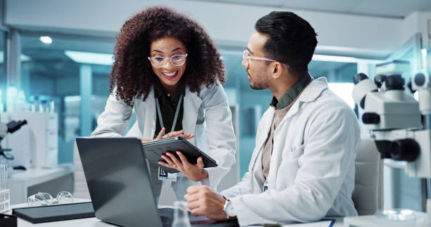 istock Science, teamwork and scientist with tablet in laboratory for communication, pharmaceutical review or planning. Employees, collaboration and technology for research, discussion and digital analysis 2036497692