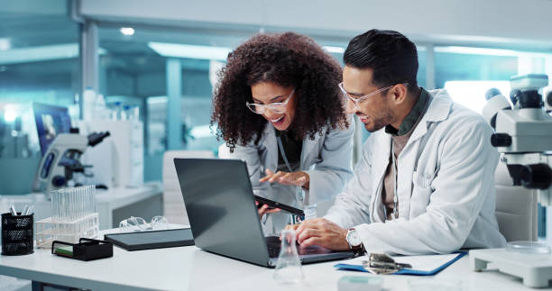 istock Science, teamwork and scientist with tablet in laboratory for communication, pharmaceutical review or planning. Employees, collaboration and technology for research, discussion and digital analysis 2036497697