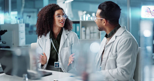 istock Science, teamwork and scientist with laptop in laboratory for communication, pharmaceutical review or planning. Employees, collaboration and technology for research, discussion and digital analysis 2036497703