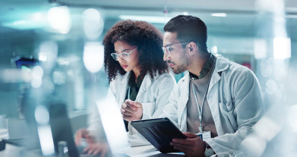 istock Science, teamwork and laptop with laughing in laboratory for communication, pharmaceutical review or planning. Employees, collaboration and technology for research, discussion and digital analysis 2036498220