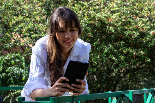 istock Beautiful young woman doing remote work outside 2036599979