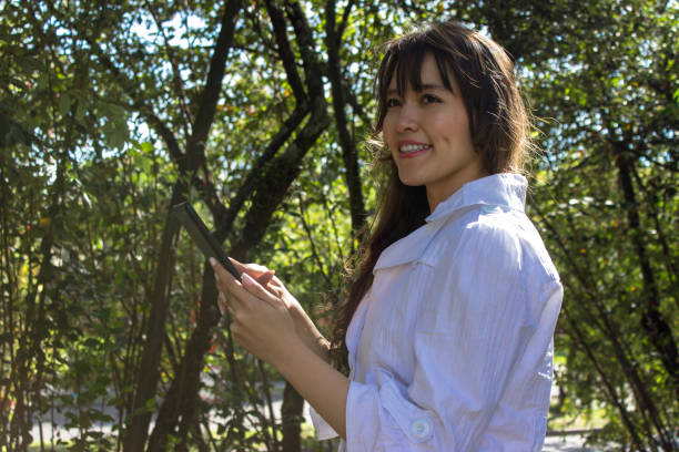 istock Beautiful young woman doing remote work outside 2036600485