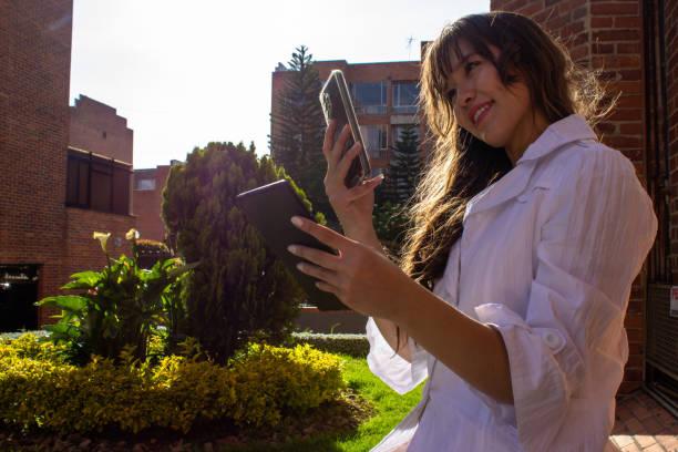 istock Beautiful young woman doing remote work outside 2036656925