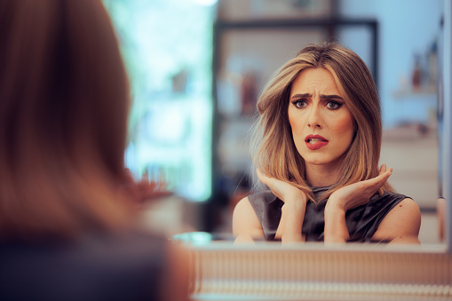 Disappointed client getting her hair cut and dyed in a salon