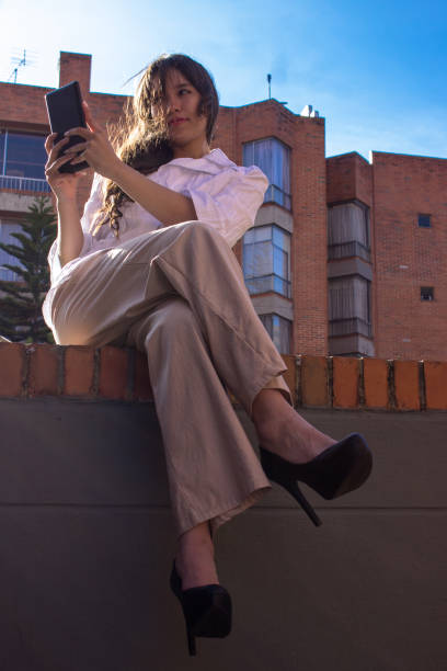 istock Beautiful young woman doing remote work outside 2036680287