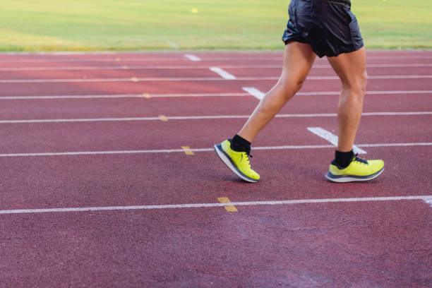istock Athlete runner feet running line on track 2036737724