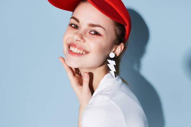 istock pretty woman in red cap earrings bright makeup close-up 2036777716