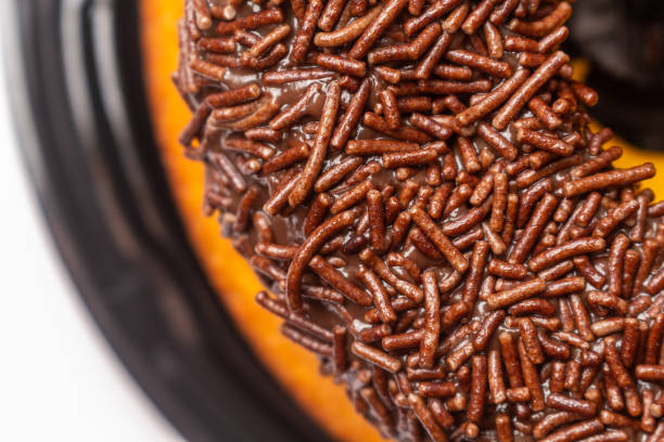 Photograph of a homemade carrot cake with brigadeiro topping and chocolate sprinkles. Traditional Brazilian dessert.
