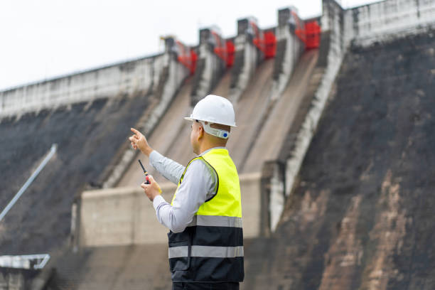 istock Professional asian maintenance engineer man with safety helmet in construction site dam with hydroelectric power plant and irrigation. Manager engineer man working at project big building. 2036838056