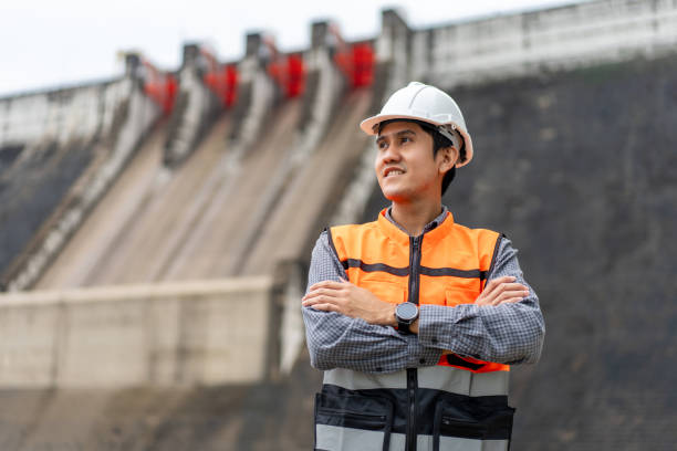 istock Professional asian maintenance engineer man with safety helmet in construction site dam with hydroelectric power plant and irrigation. Manager engineer man working at project big building. 2036843670