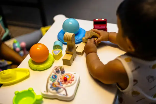 Asian baby Toddler playing colorful blocks.