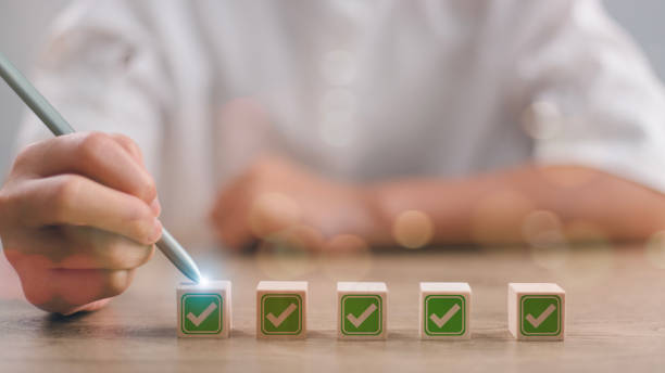 istock Checklist concept, Hand holding stylus pen checking mark on checkboxes. 2036848371
